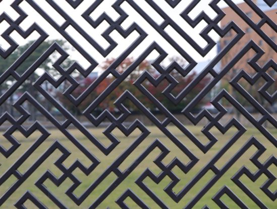 Straight image of a patterned steel fence.